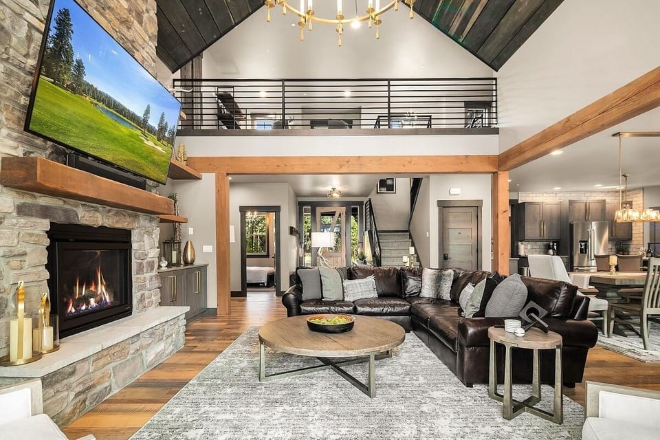 Great Room – Entry Lounge with Designer Lighting, Gas Fireplace, and Oversized Gathering Sofa.