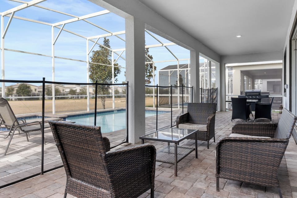 Relax on your covered lanai with wicker seating overlooking your private screened pool and peaceful neighborhood views.