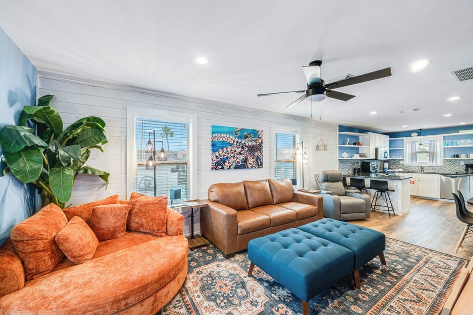 Unwind in your spacious open-concept living area where rich leather seating and vibrant accents create the perfect spot for relaxation.