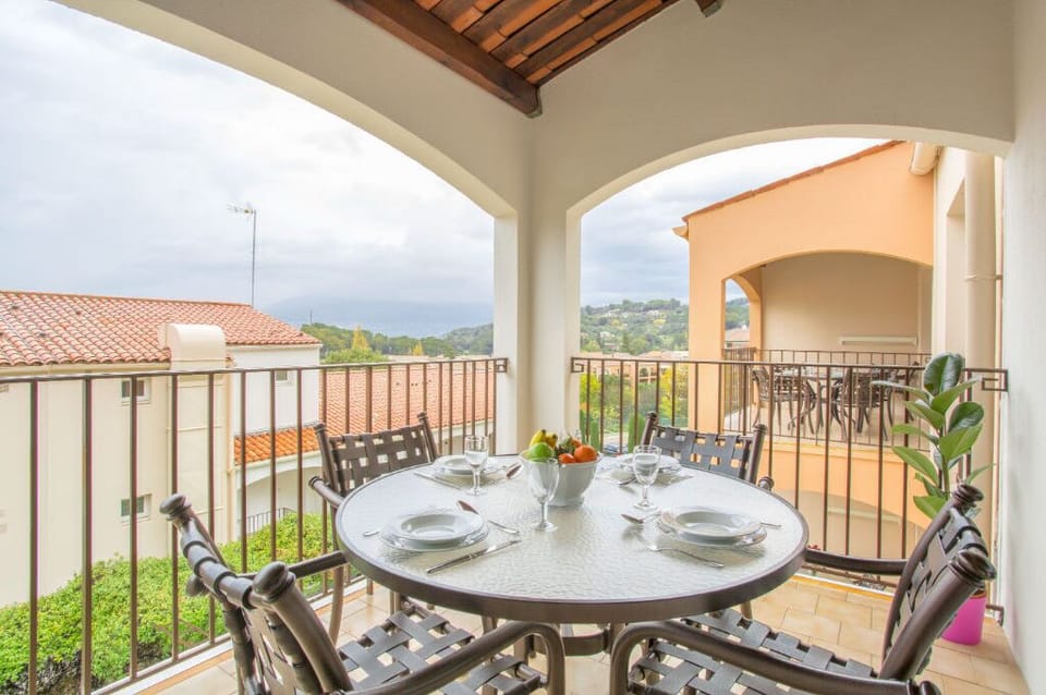 Alfresco dining setup on a cozy balcony with scenic views.