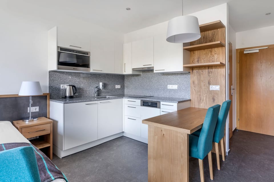 Warm and functional dining space beside the kitchenette – enjoy meals in comfort with all the essentials provided.