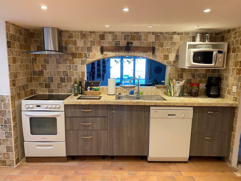 Lower level full kitchen, pots and pans, Bosch dishwasher, oils, spices, vinegar