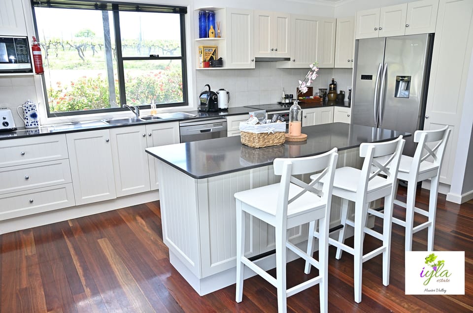 Fully equipped kitchen with coffee machine, kettle, microwave, fridge and stove