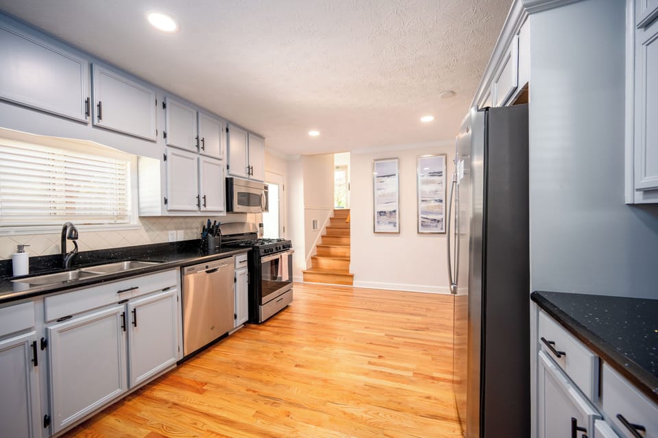 Bright kitchen w/ stainless appliances, toaster oven and coffee maker