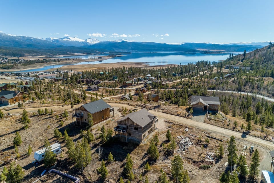 Drone view showing back of cabin and views of Lake Granby. 