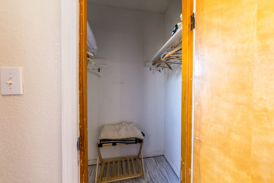 Bedroom closet with suitcase holder