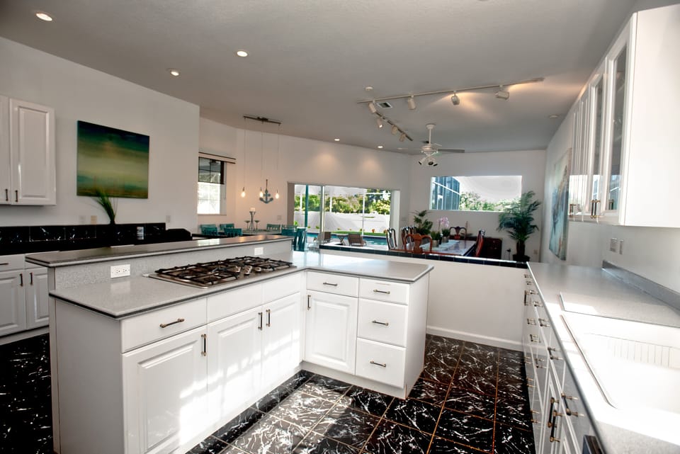 Kitchen w counter bar and dining and high top tables