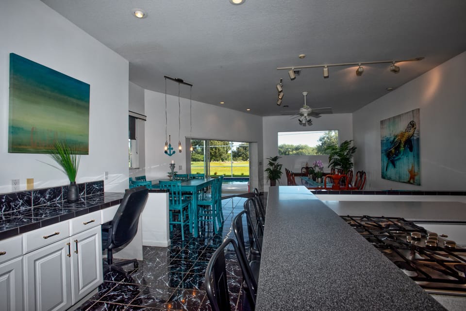 Kitchen showing counter bar, high top and dinner table plus home office area