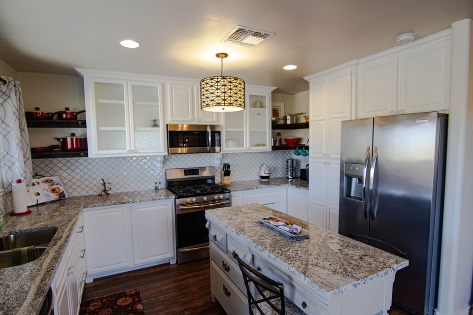 granite countertops, 5 burner gas stove stainless appliances and tons of storage