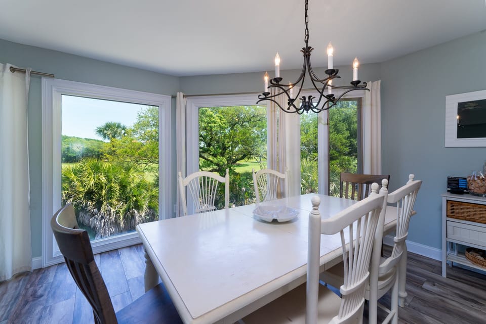 The dining area has floor to ceiling windows. The table easily seats 6.