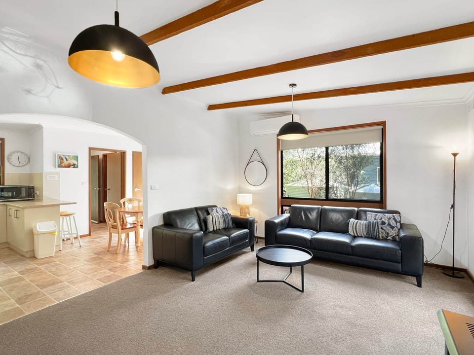 Unwind in luxury: leather sofas, cozy log fire, perfect for cherished moments.