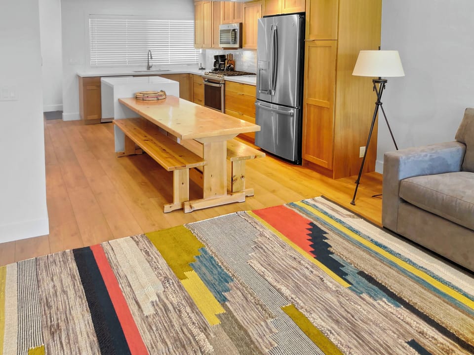 Your open-concept kitchen is ready for meal prep with modern stainless steel appliances, warm wood cabinetry, and plenty of counter space to spread out and cook comfortably.