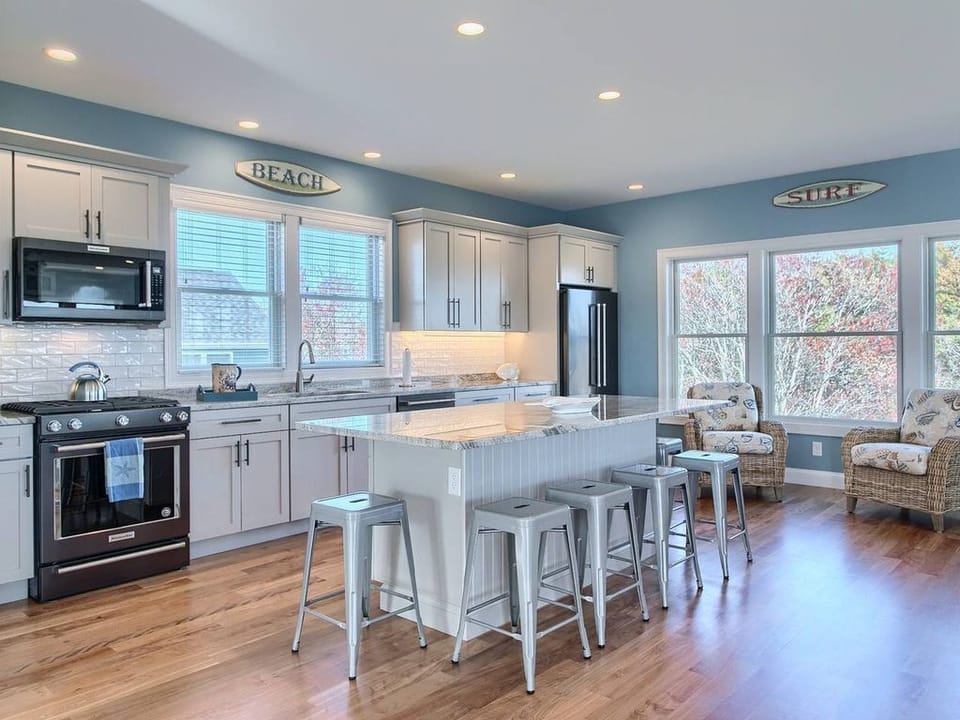 Open concept kitchen with high-end appliances and large island.