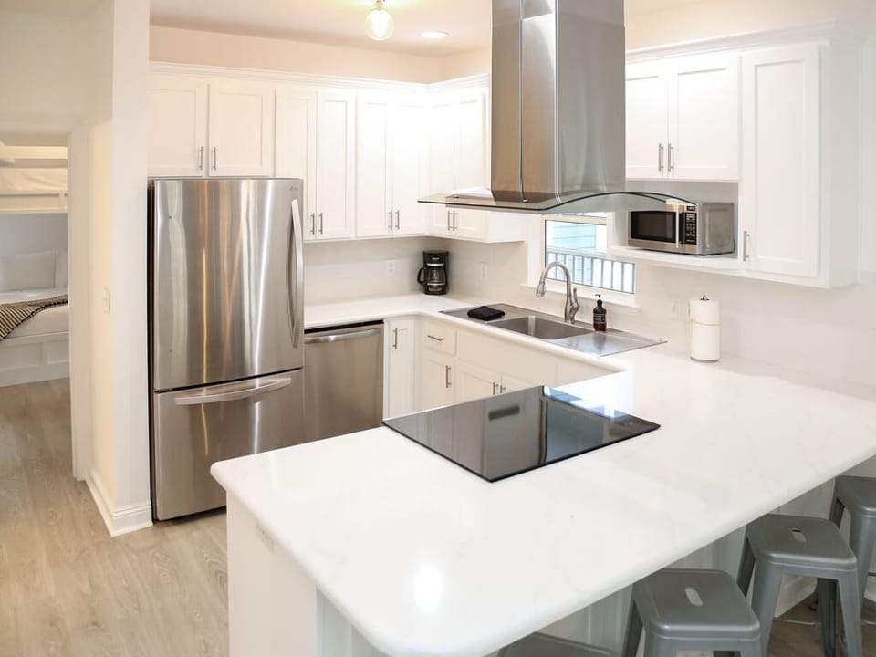 - Cook up in this fully stocked kitchen with stainless steel appliances - Spacious countertops, modern range, & bar seating make it perfect for morning coffee or happy hour - Whether you're a chef or just reheating leftovers, this kitchen’s got you c