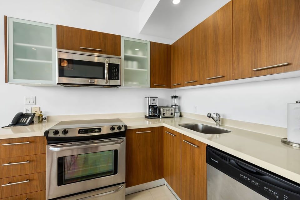 Your fully equipped kitchen features sleek stainless appliances, warm wood cabinetry, and everything you need to whip up a quick breakfast or home-cooked meal during your stay.