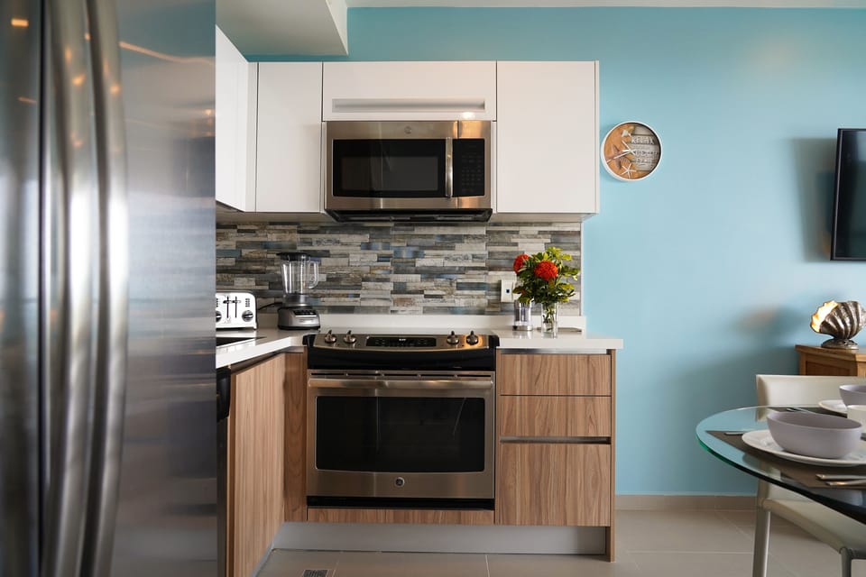 Your fully equipped kitchen features stainless steel appliances, stone-style backsplash, and everything you need to prepare delicious meals in this bright, modern space.