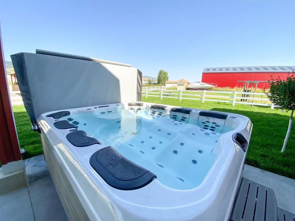 Soak, unwind, and enjoy serene views from this luxurious outdoor hot tub retreat.