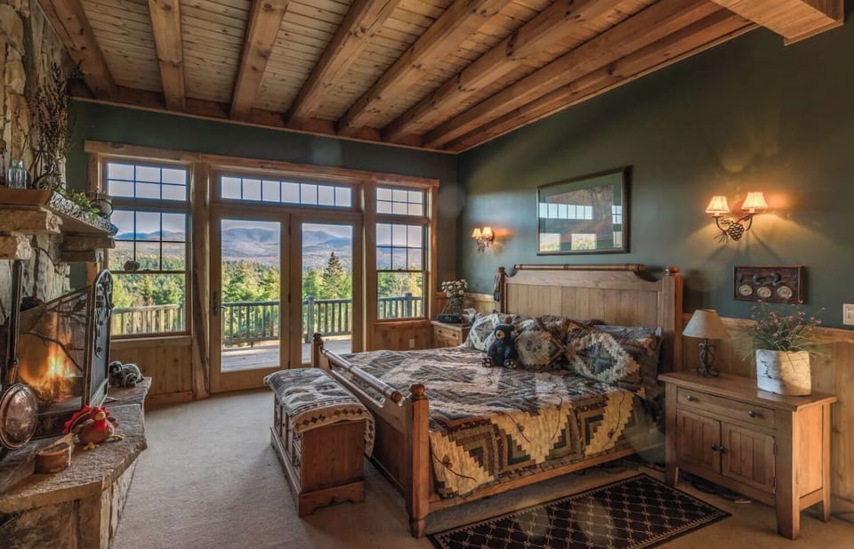 Master bedroom with wood-burning fireplace. King-size bed