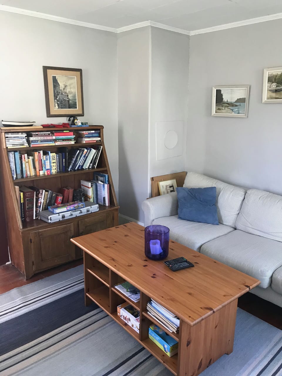 Living has two chairs, a couch and bookcase