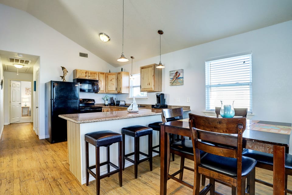Dining area with seating for eight and beachy decor
