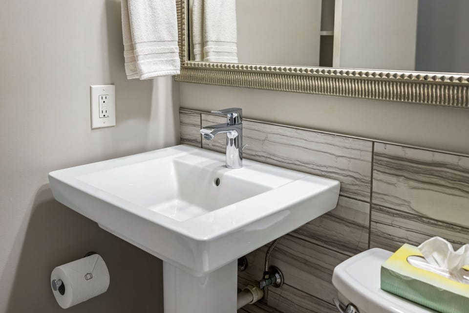 Brookwood Courtyard Condos - Modern Bathroom a Large Mirror