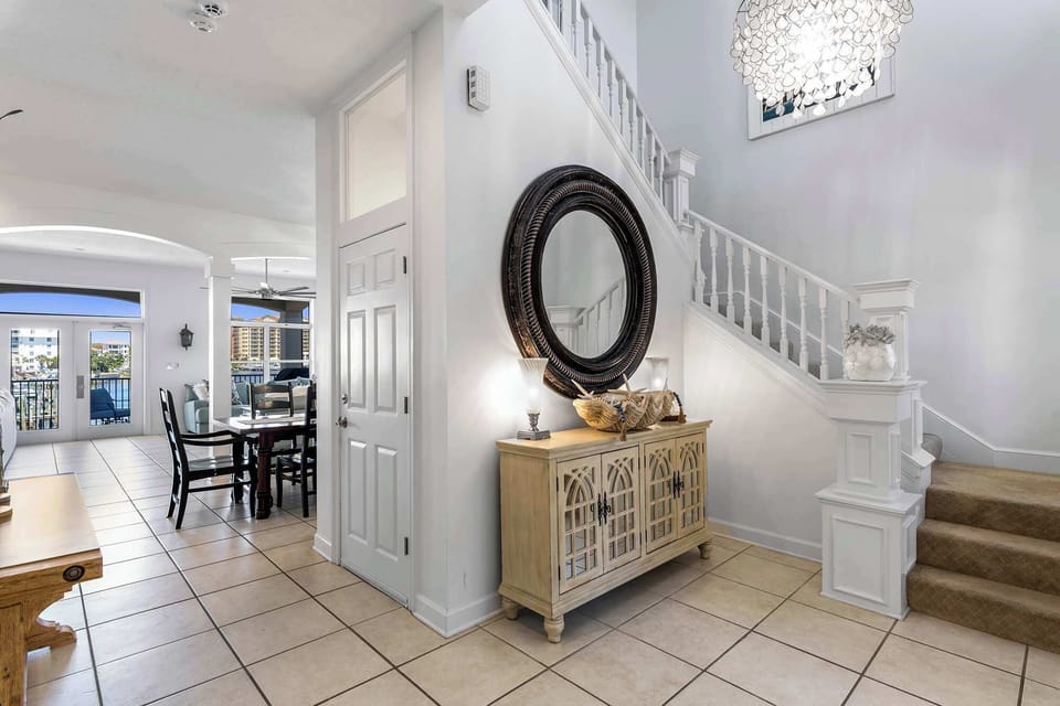 Stylish entryway w/ console table, mirror, & welcoming coastal touches.