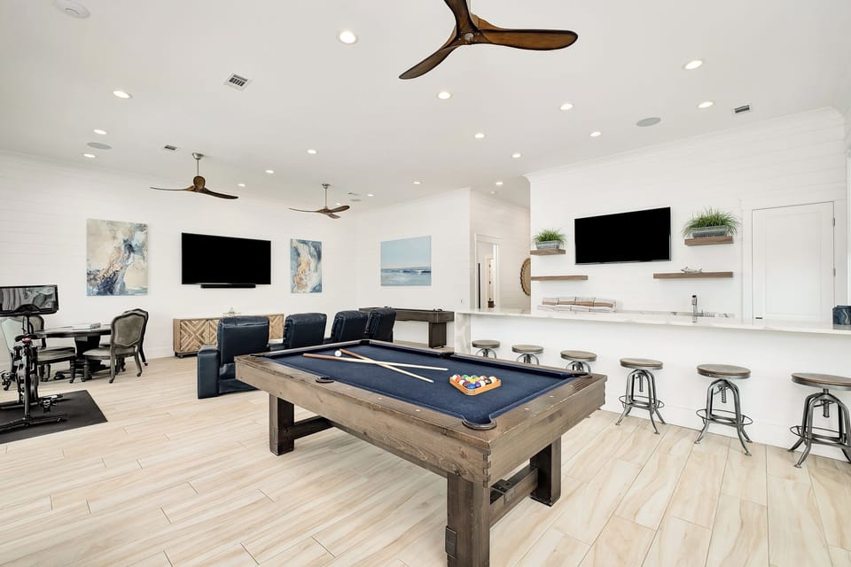 Your personal entertainment paradise awaits with a premium pool table, spacious bar seating, and multiple viewing areas for unforgettable gatherings.