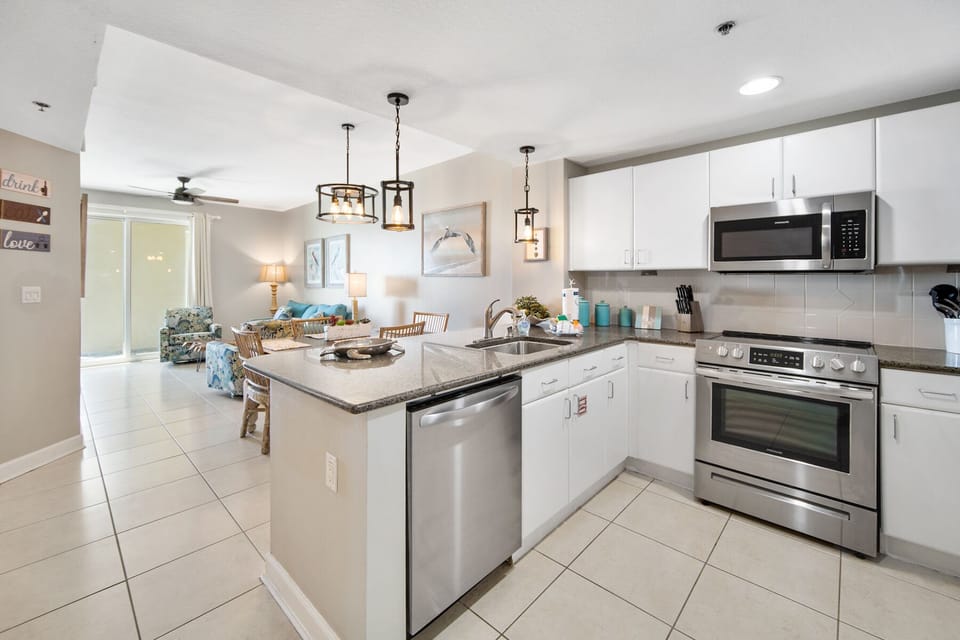 Your modern kitchen features granite counters, stainless appliances, and stylish pendant lighting—perfect for preparing vacation meals together.