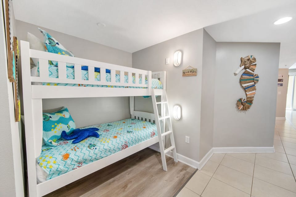 Your kids will love this playful ocean-themed bunk room, complete with cheerful sea life bedding and whimsical seahorse wall art.