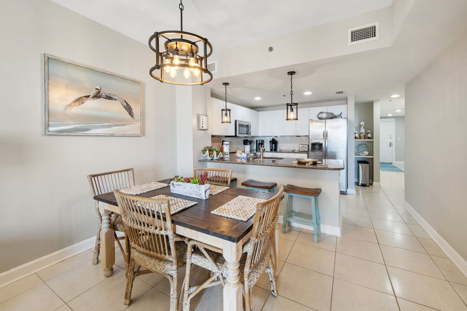 You'll love sharing meals in this bright dining space with coastal charm and an open kitchen for easy entertaining.