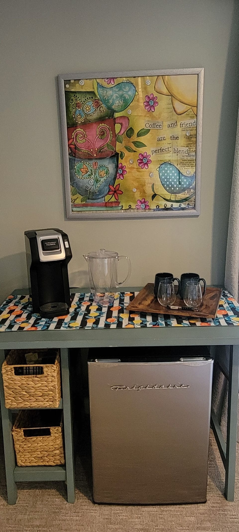Coffee and wine station with refrigerator and coffeemaker. 