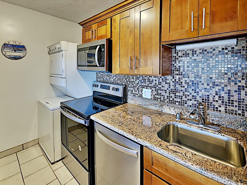 Enjoy a homecooked meal with everything you could need supplied in the condo kitchen.