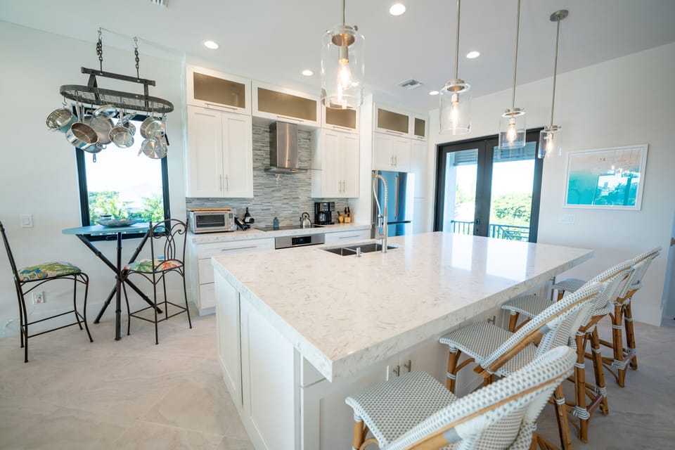 Large professional grade kitchen with bar and bistro seating for 6