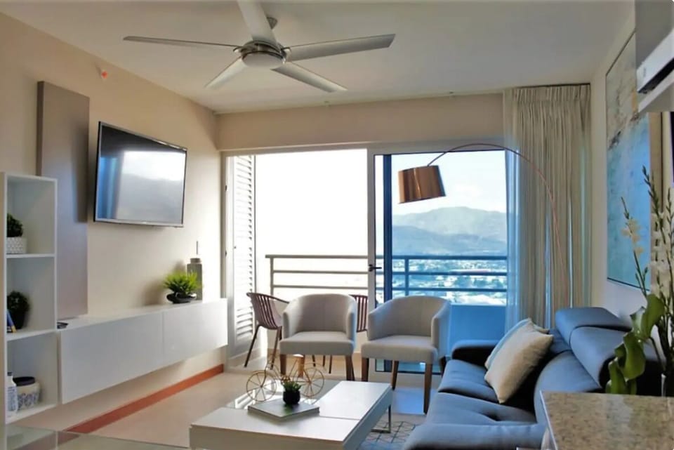 Living room with access to balcony and sofa bed