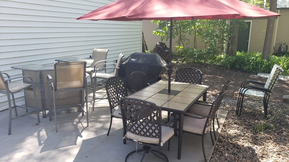 Out door bar, patio table and grilling area with lights for night time sitting.