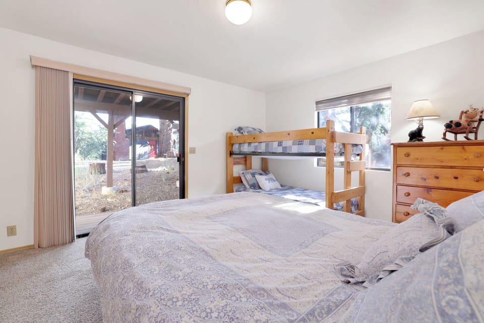 Peaceful cabin bedroom with plush bedding, and beautiful views—ideal for restful nights, cozy mornings, and a relaxing mountain escape.