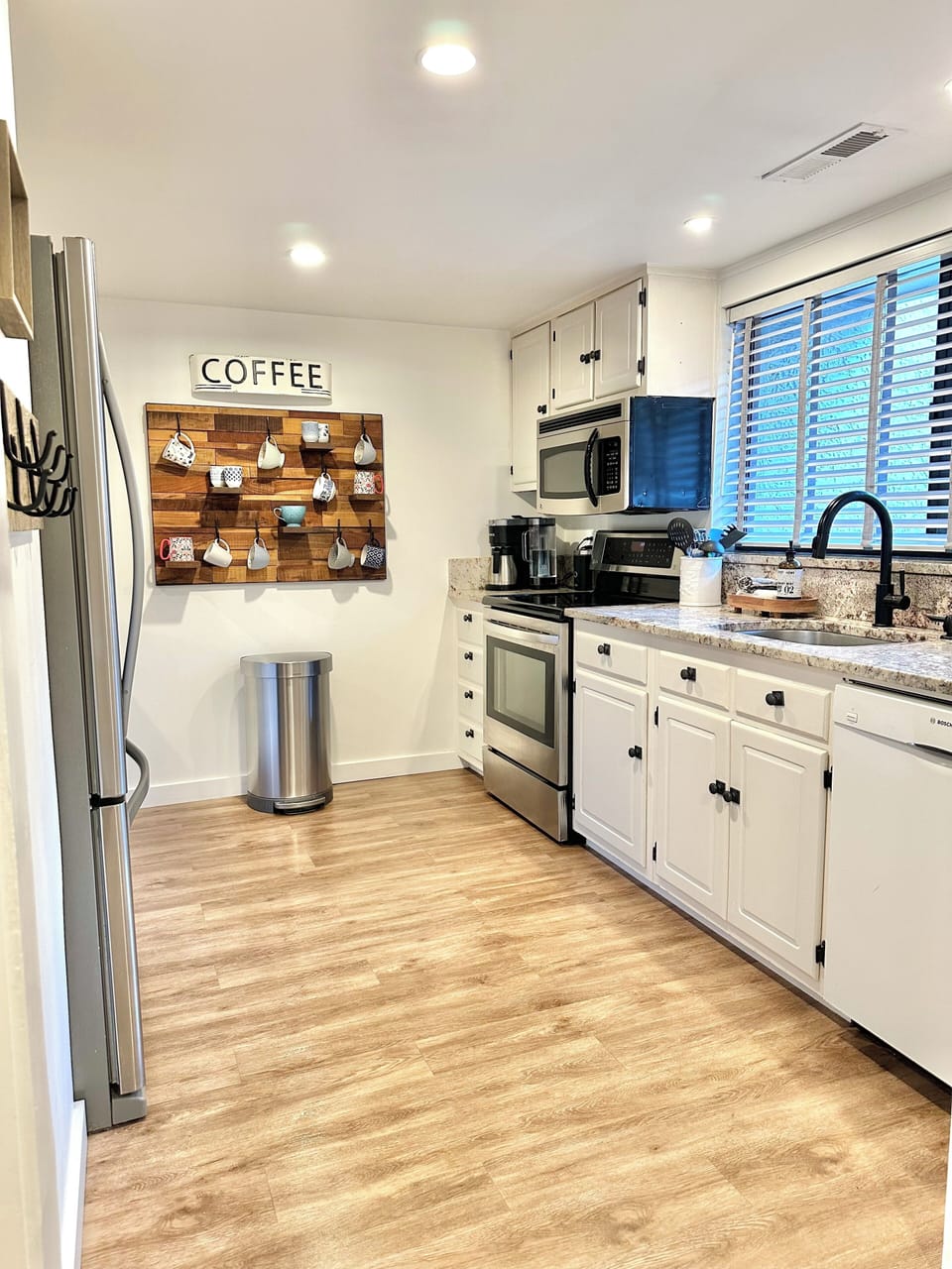 Fully outfitted kitchen overlooks front courtyard.