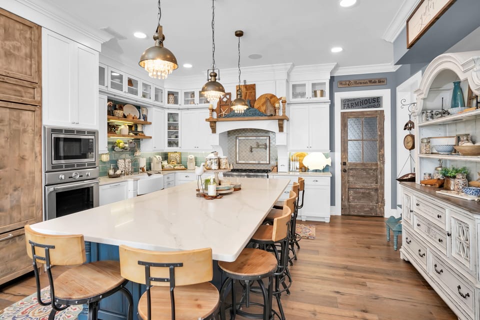 Step into this stunning farmhouse kitchen where you'll create unforgettable meals. From the spacious island to cozy breakfast bar, every detail invites culinary adventures.