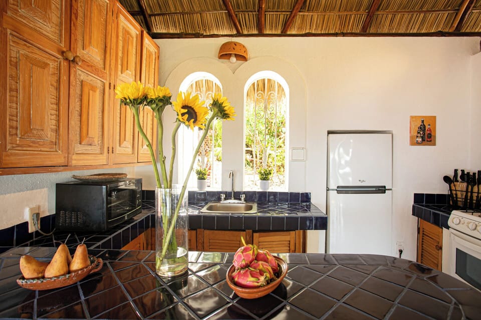 Full size kitchen, bar separating it from the dining area.  Ocean views
