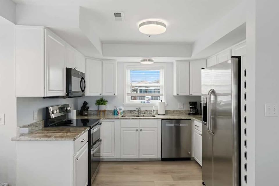 Kitchen: Modern space with sleek appliances and bright windows for delightful cooking adventures!