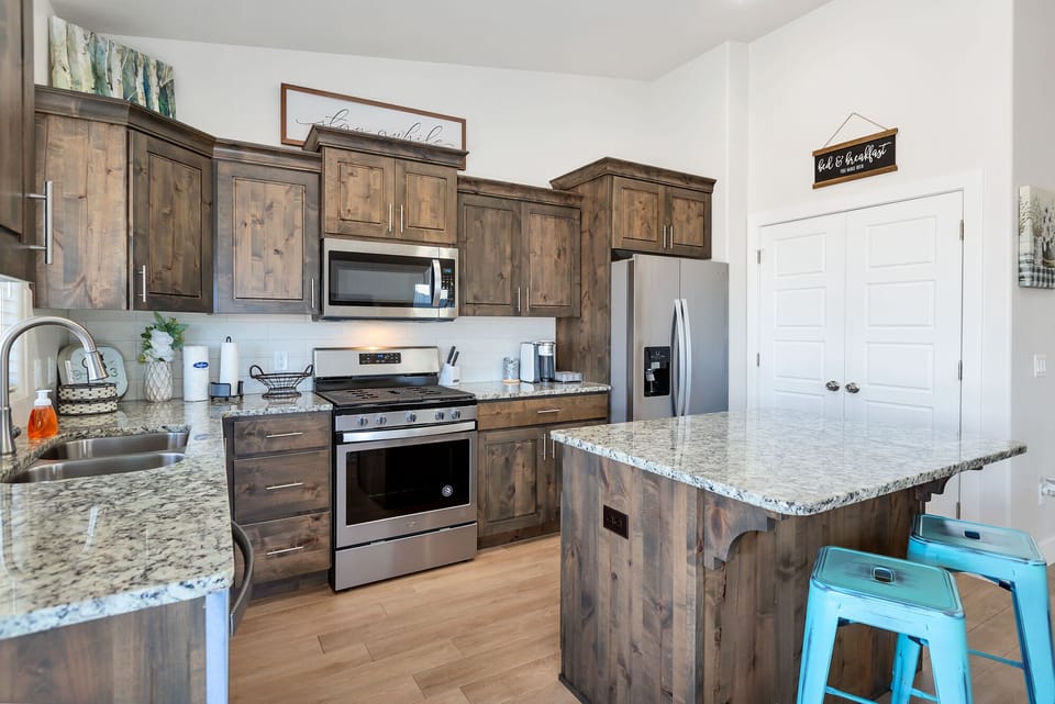 Fully stocked gourmet kitchen featuring top of the line appliances