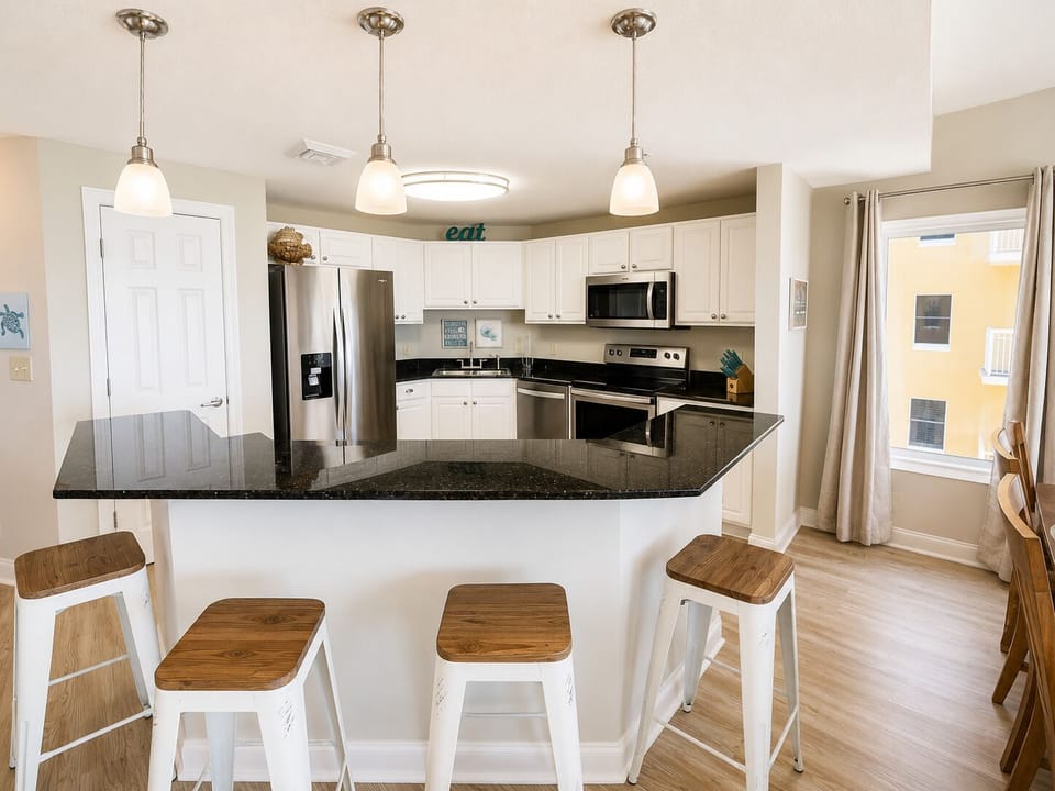 Your fully equipped kitchen features granite countertops, modern appliances, and a breakfast bar perfect for morning coffee or casual meals.