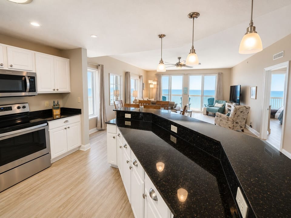 Your gourmet kitchen features granite countertops and opens to stunning ocean views, perfect for cooking while enjoying the sea breeze.
