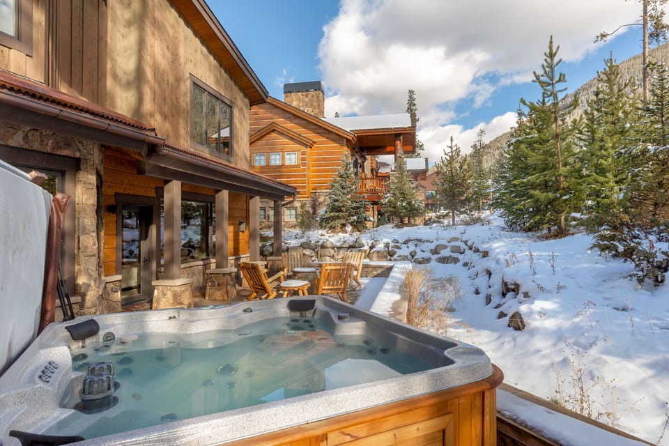 Soak in your private hot tub while snow glistens around this mountain retreat, complete with cozy patio seating.