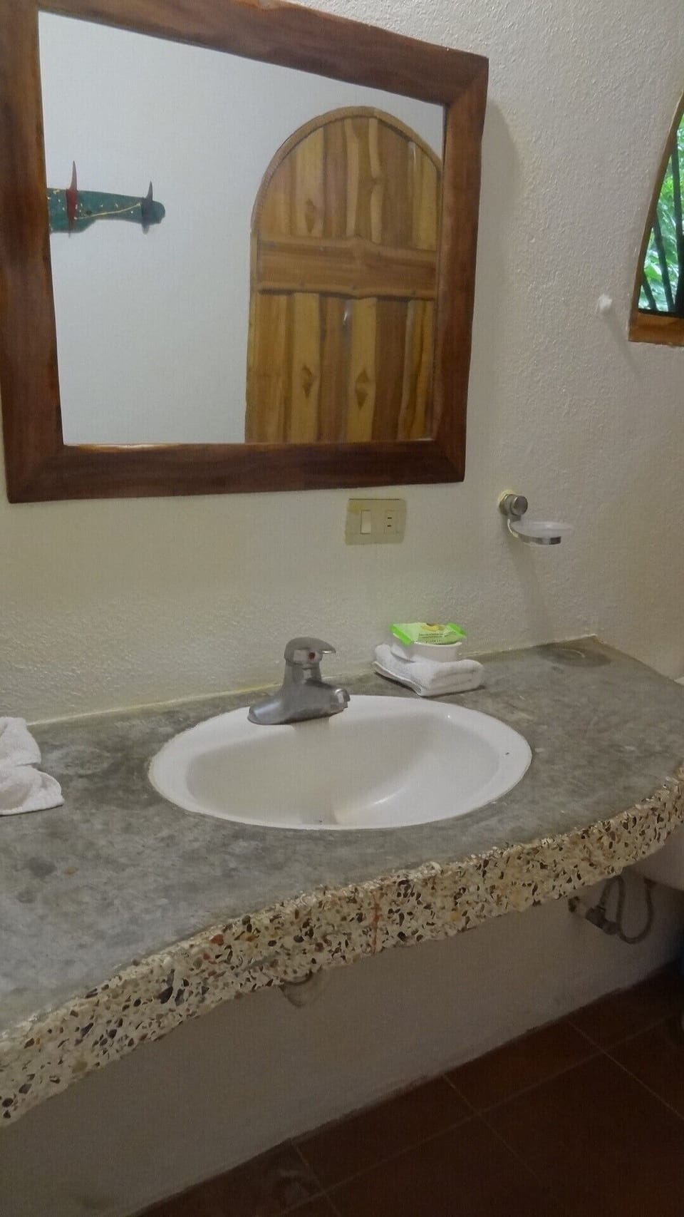 This bathroom has natural stone work for both the sink and shower.