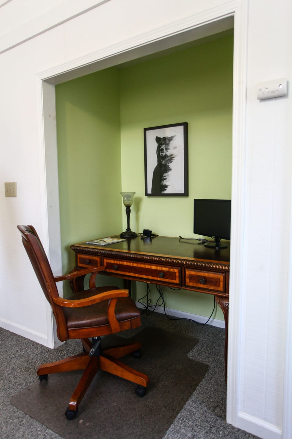 The upstairs master bedroom has a writing desk with convenient charging block