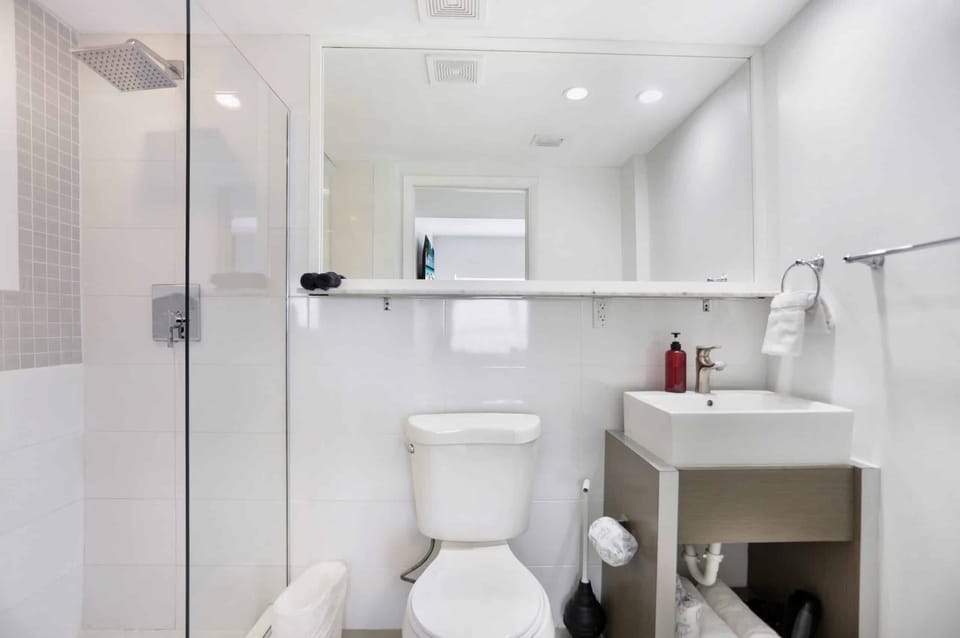 Refresh under the rainfall shower in a spotless modern bath.