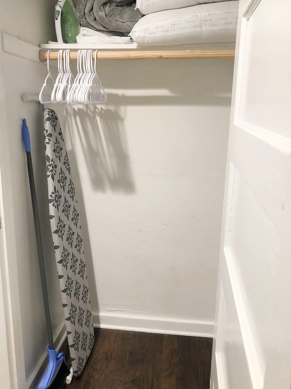 Ironing board and broom