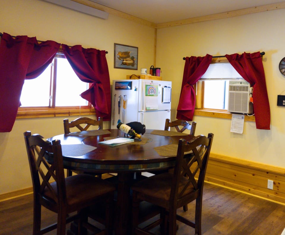 Bar height table, window ac, and fridge/freezer