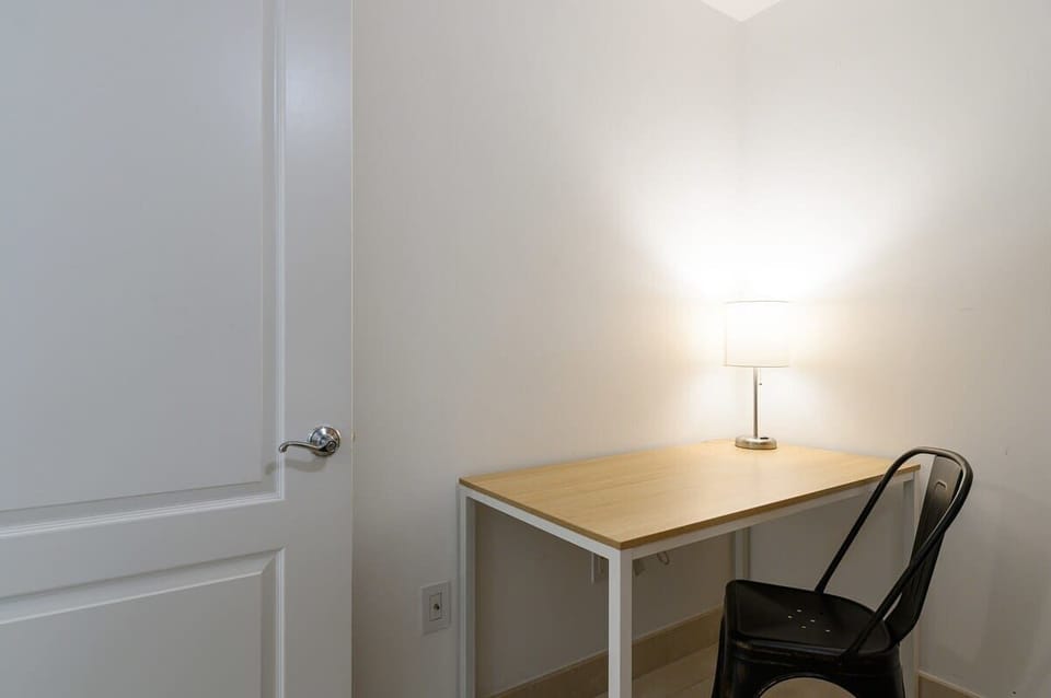A quiet corner for remote work or journaling, complete with warm lighting and a sleek desk setup.

